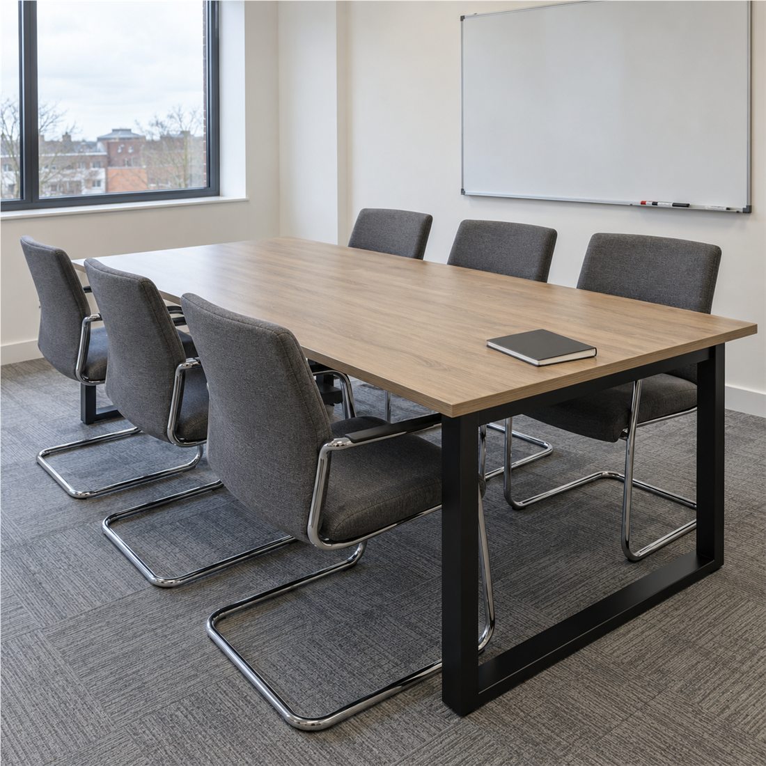 Boardroom table, meeting chairs and whiteboard in a modern meeting room