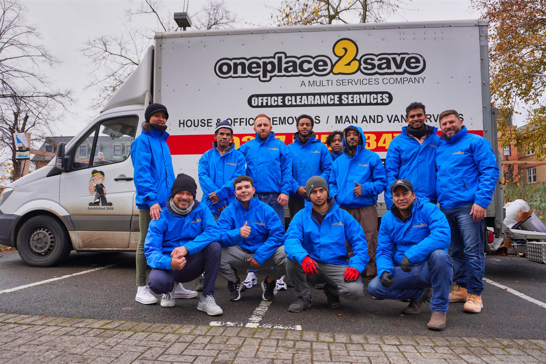The My Used Furniture and OnePlace2Save team beside a company vehicle