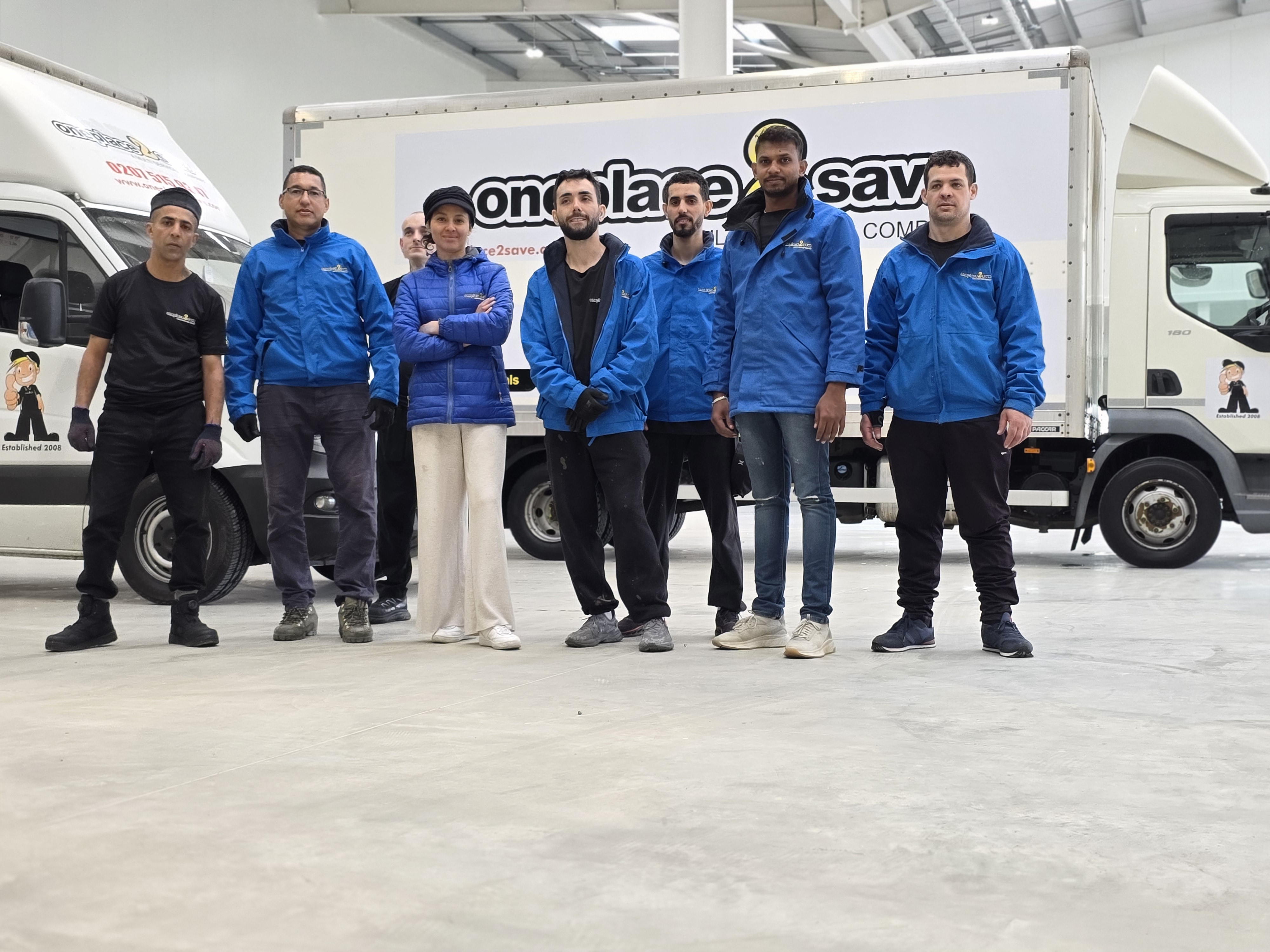 The OnePlace2Save and My Used Furniture team with the company vehicles