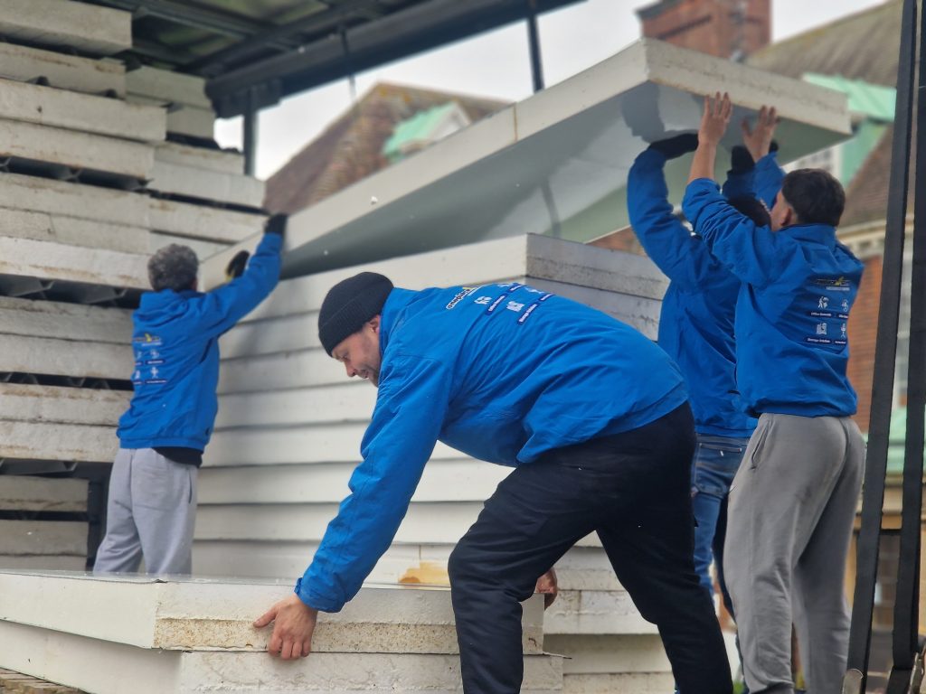 Oneplace2save team loading stacked panels onto a lorry during waste removal and site clearance