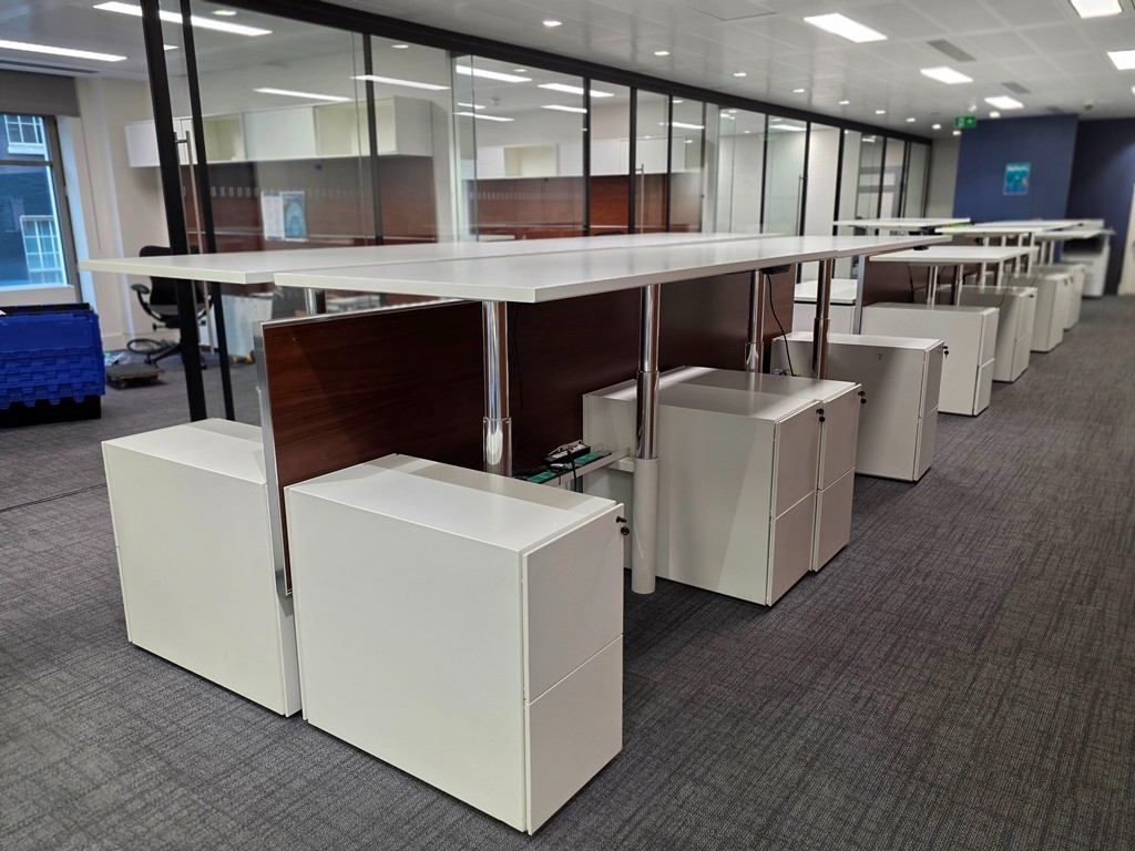 Used sit-stand office desk adjusted for standing work