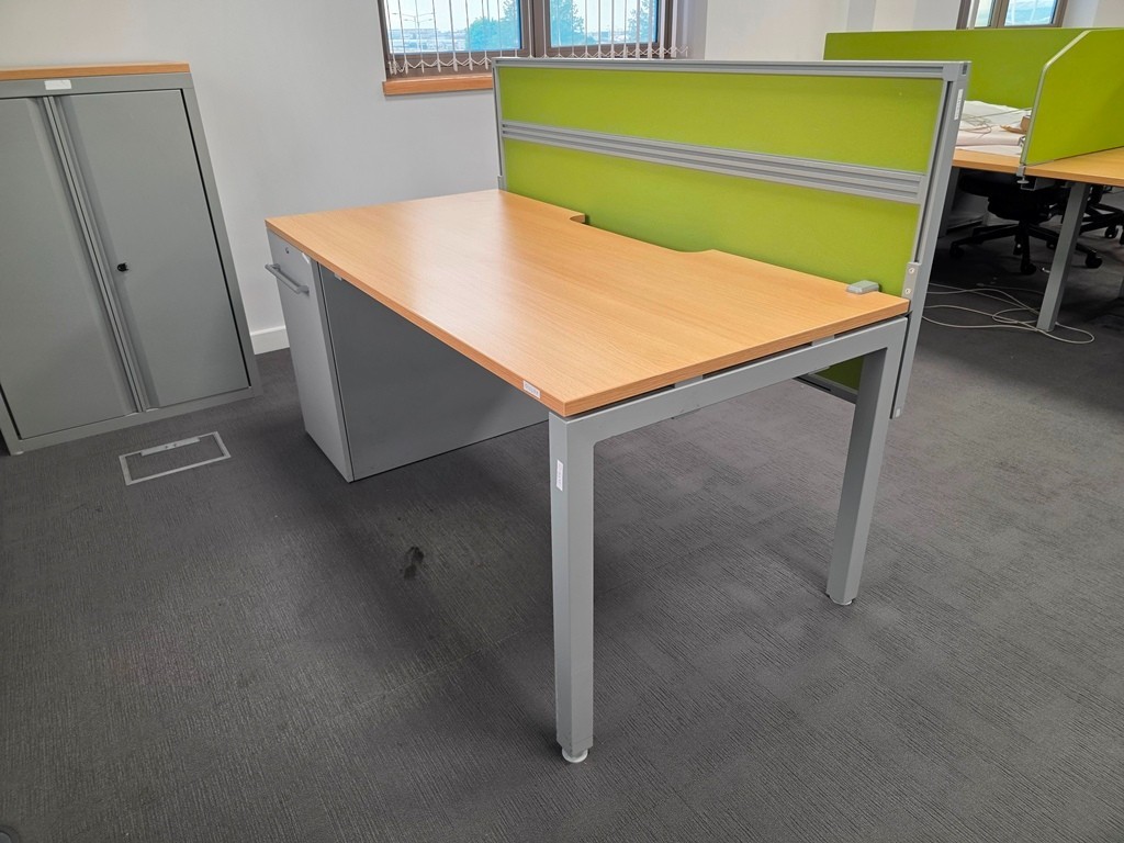 Used rectangular office desks arranged as individual workstations