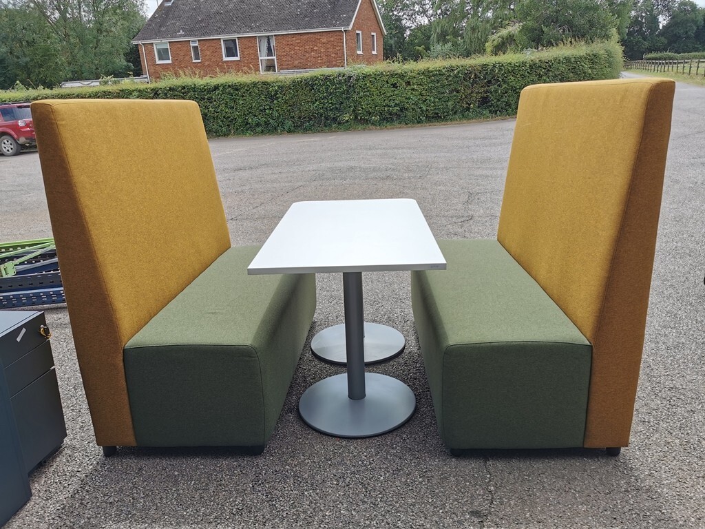 Used stools, sofas and high-back booth seating in an office breakout area