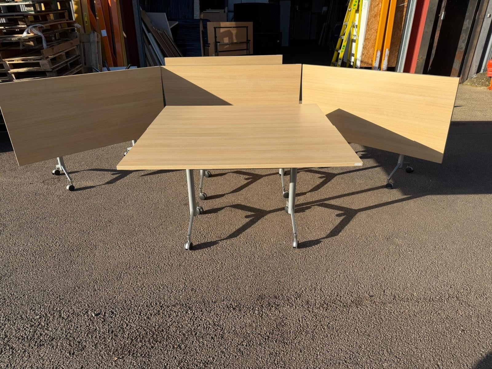 Used flip-top Herman Miller for sale lined up outside My Used Furniture warehouse