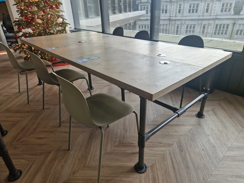 Used office meeting and collaboration tables arranged in a modern UK workplace