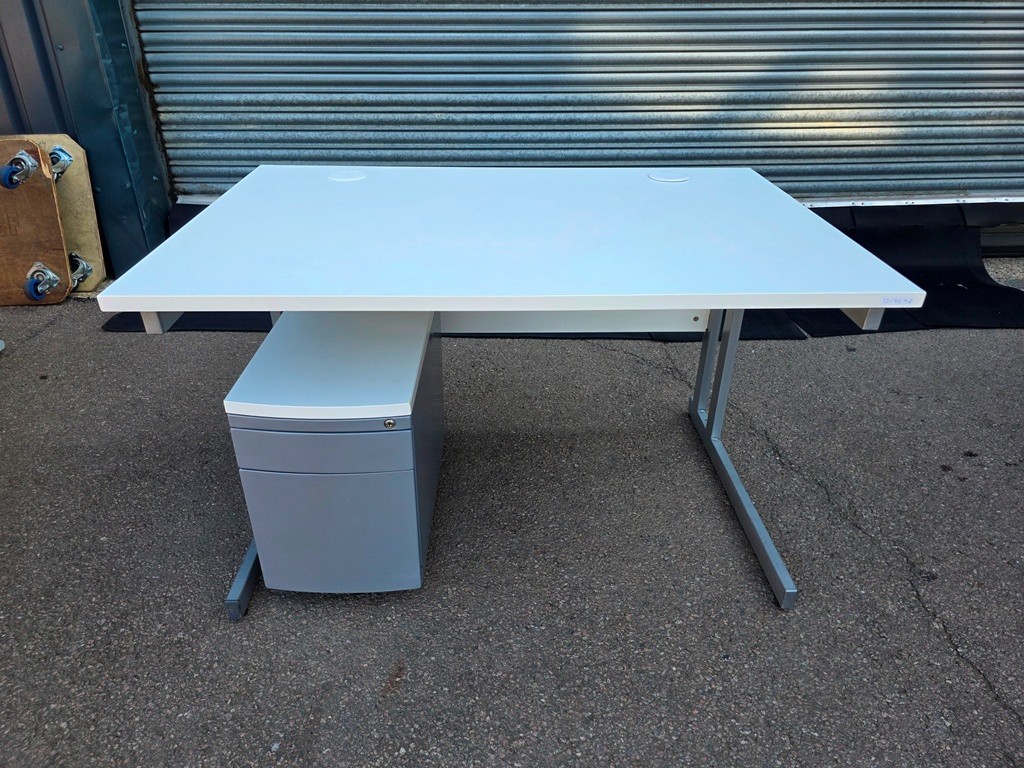 Desk-high filing pedestal positioned beside a used office desk