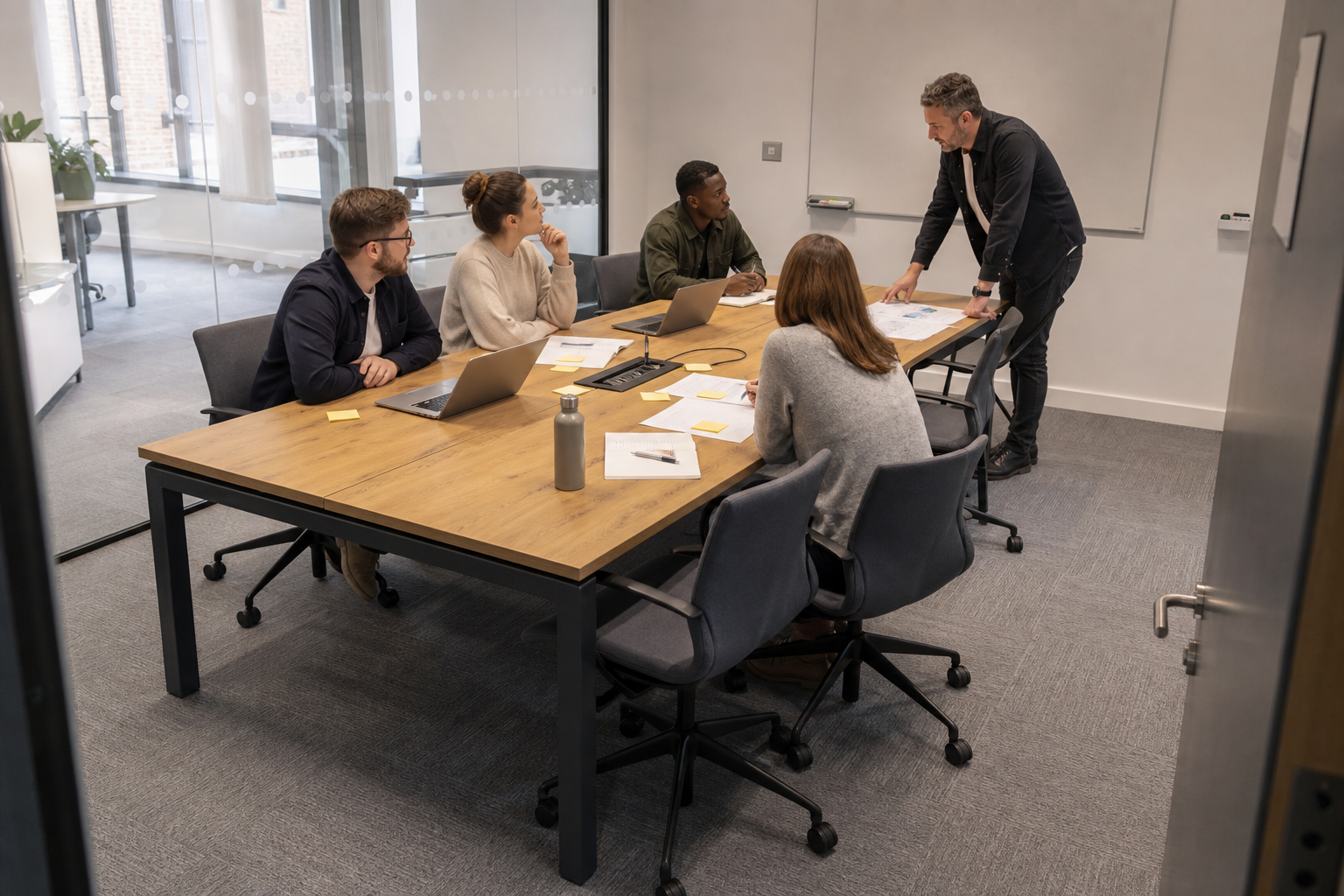 Project team using a reused collaboration table with shared power and clear access