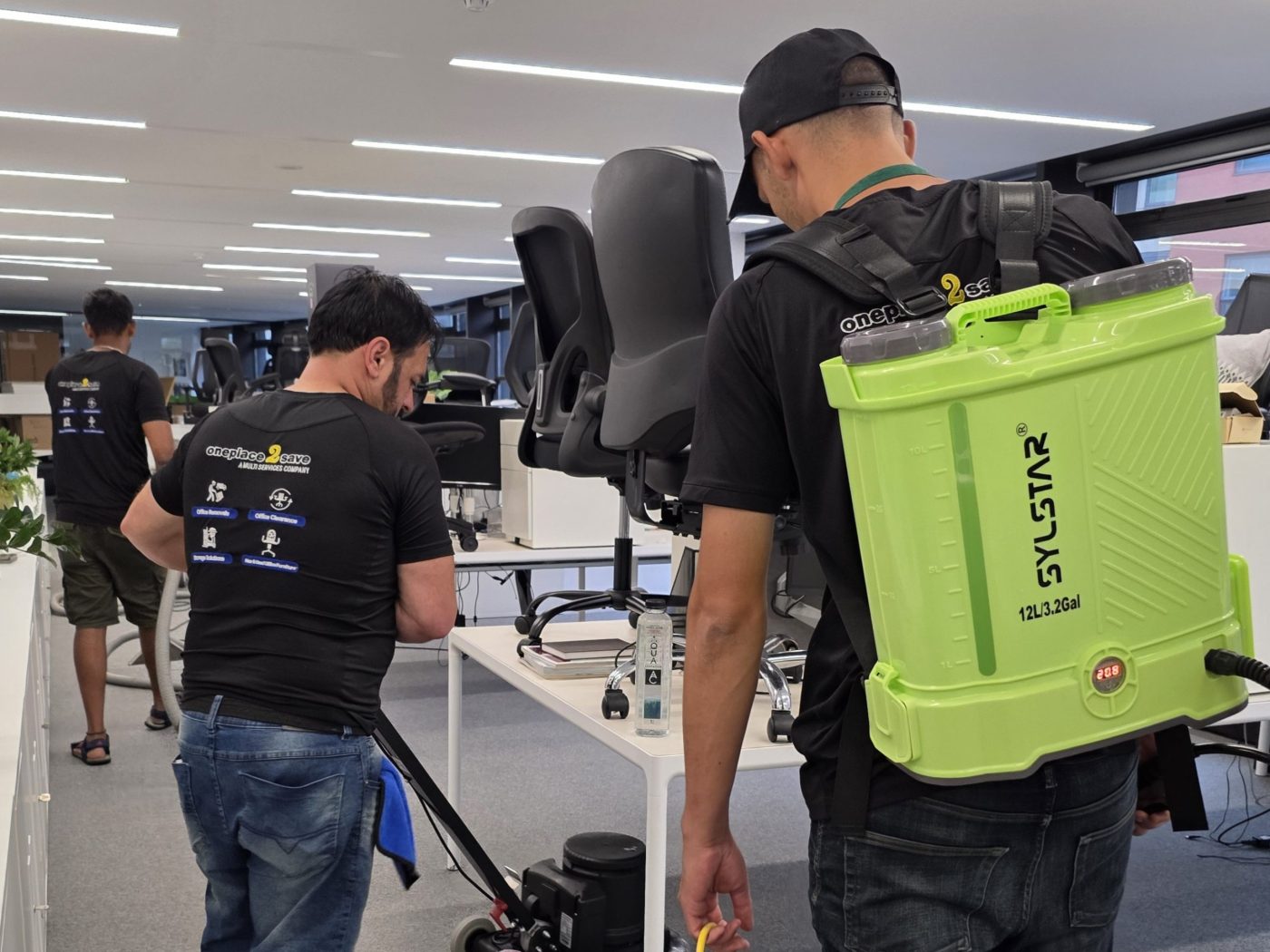 Oneplace2save team cleaning and prepping desks and chairs during an office clearance